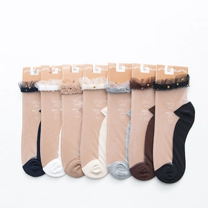 Detail of sheer tulle socks with lace trim and gold star sequins in various colors