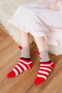 Close-up of cozy coral fleece Christmas socks with 3D bear ears and red stripes