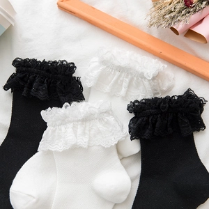 White and black mid-calf lolita socks with delicate lace ruffles and knit texture