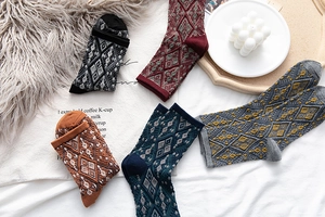 Detail of five pairs of vintage argyle mid-calf socks in warm autumn color tones