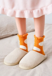Close-up of thick coral fleece polka dot socks with plush slippers for home warmth