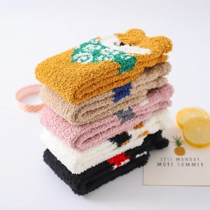 Detail of five assorted thick coral fleece socks with cute cartoon animal patterns