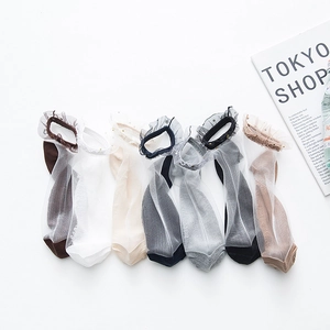 Close-up of seven colors of sheer mesh socks with star lace trim and cotton soles