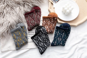 Detailed view of vintage diamond pattern knit socks in various warm autumn colors