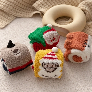 Close-up of four pairs of thick coral fleece Christmas socks with 3D cartoon embroidery