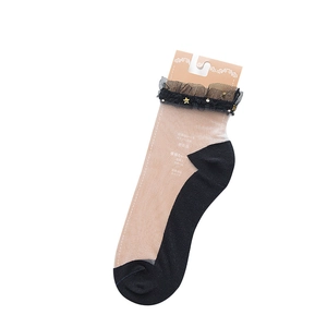 Sheer beige ankle socks with black lace trim and gold star sequins on a white background