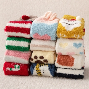 Detailed view of colorful coral fleece Christmas socks set with cute 3D cartoon patterns