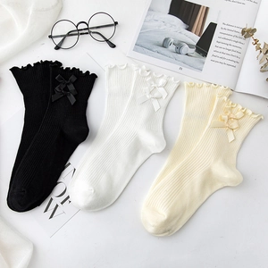 Three pairs of Lolita style mid-calf socks with ruffle edges and double bow decoration