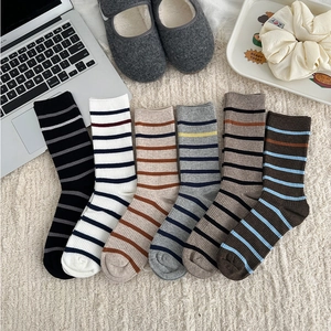 Detail showing set of six knitted mid-calf socks with classic striped patterns in various colors