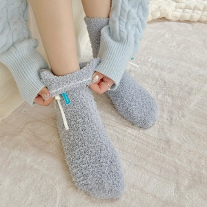 Detail of soft grey coral fleece floor socks with cute bow and cozy high-top cuff