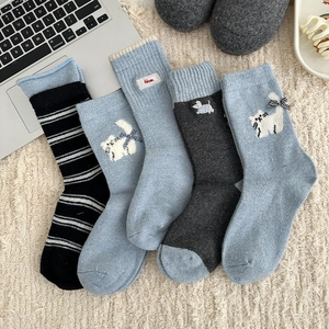 Detail of wool socks set featuring cute animal embroidery and stripe patterns