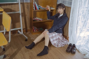 Detail of JK uniform outfit featuring dark blue blazer and pink-purple plaid pleated skirt