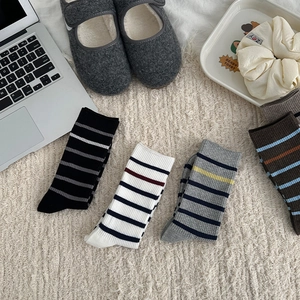 Detail of striped cotton crew socks in various colors with soft ribbed knit texture