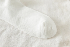 Detailed close-up of smooth toe seam and fine rib texture on white Lolita JK socks