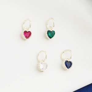 Detailed view of four S925 sterling silver heart pendants with colorful zircon stones