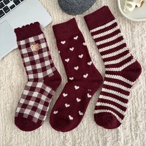 Three pairs of festive red warm socks with bear embroidery heart and stripe patterns