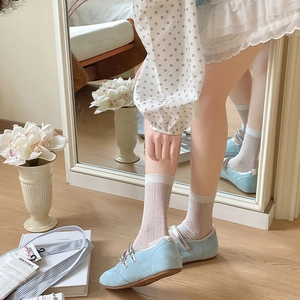 Detail of sweet bow mesh socks paired with light blue flat shoes and lace trim