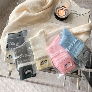 Five pairs of colorful mid-calf socks with cow embroidery in transparent packaging