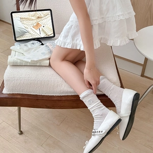 Detail of white cotton crew socks with cute bear embroidery and ruffle edge design