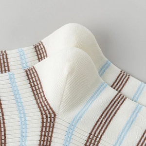 Detailed macro view of the high-density ribbed knit and striped pattern on the cotton sock