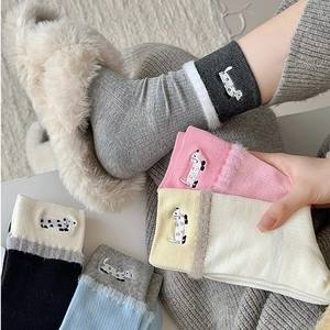 Detail of plush faux fur cuffs and cute puppy embroidery on colorful crew socks