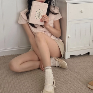 White vertical stripe socks with lace edges styled with beige Mary Jane shoes