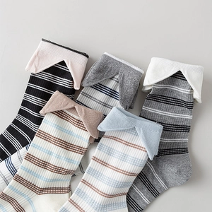 Close-up of five pairs of striped crew socks featuring unique triangle fold cuffs