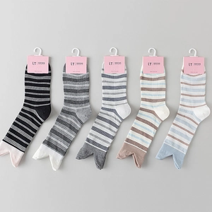 Set of five striped crew socks in diverse colors with premium cardboard packaging