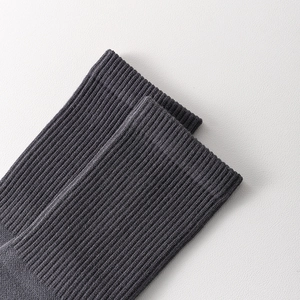 Detail view of ribbed cuff on dark grey five-toe socks with fine cotton blend stitching
