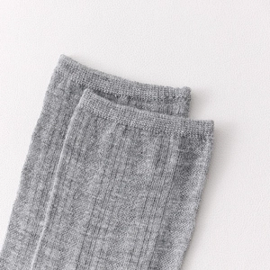 Close-up of the ribbed elastic cuff on grey vintage style mid-calf socks for women