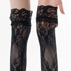 Close-up of black lace thigh-high stockings featuring delicate floral mesh pattern