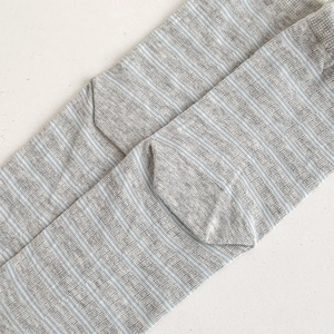 Close-up of gray and blue striped cotton socks with textured knit and natural finish