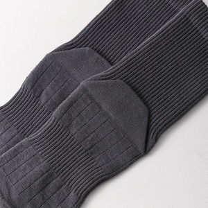 Detail of dark grey ribbed knit five-finger socks with elastic cotton texture and heel