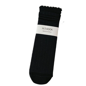 Sweet cream style black crew socks with ribbed texture and decorative scalloped lace cuffs