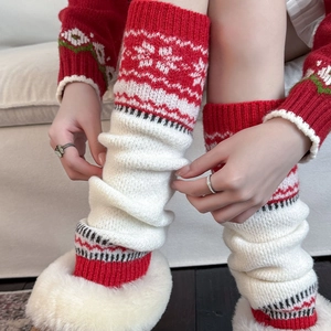 Detail of knitted leg warmers featuring red snowflake jacquard and vintage Christmas style