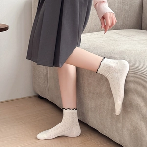 Japanese style frill socks in off-white with heart cutouts and ruffled black trim edge