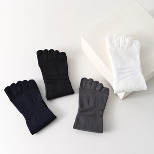 Close-up of assorted five-finger toe socks in black, navy, grey, and white knit fabric