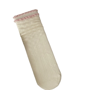 White ribbed crew socks with pink ruffled edges and vertical knit pattern for women