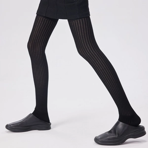 Dettaglio della texture a coste nere su eleganti calze sopra il ginocchio da donna