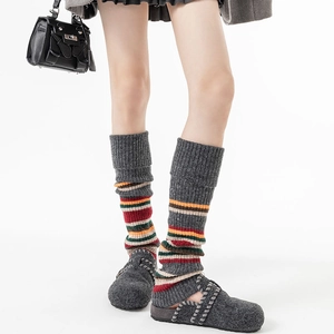 Detail of vintage striped knit leg warmers in dark grey with colorful ribbed textures