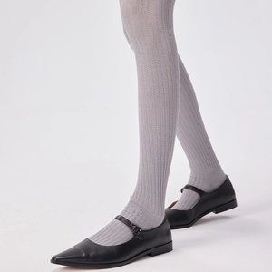 Light gray vertical striped over-the-knee socks paired with black Mary Jane shoes