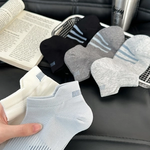 Close-up of low-cut cotton sports socks with blue striped heel and ribbed mesh texture