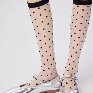 Vintage polka dot sheer calf socks for women paired with metallic Mary Jane shoes