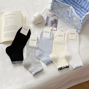 Flat lay of five pairs of sweet ruffle trim socks in pastel colors on a white background