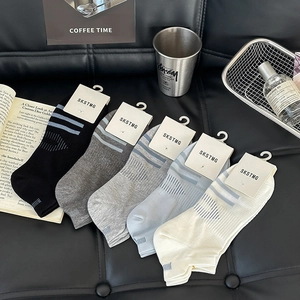 Flat lay of five color mesh breathable low cut socks on a stylish leather background
