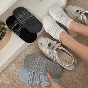 Detail view of colorful striped invisible boat socks in various colors on cozy background