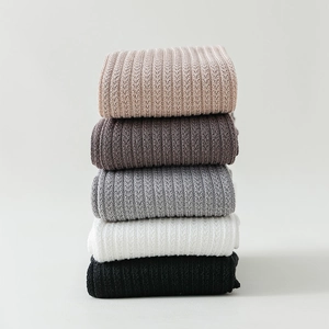 Detailed close-up of ribbed texture and hollow-out dots on five pairs of cotton socks