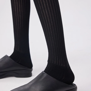 Modern black over-the-knee socks with ribbed vertical stripes and slim fit design