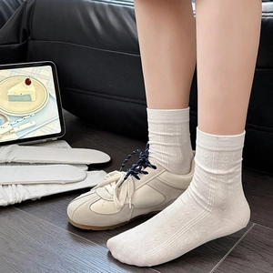 White Japanese crew socks with heart patterns and cable knit texture for a sweet look