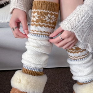 Brown and white knit leg warmers with snowflake pattern and plush faux fur trim